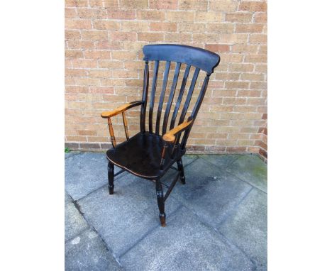 A COMB BACK WINDSOR ARMCHAIR  on double H-shape stretcher base, the dished elm seat 47cm wide 48cm deep, 113cm high overall