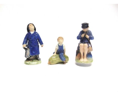 THREE ROYAL COPENHAGEN FIGURES:  Boy with Umbrella 3556, Boy sitting on a large marrow 4535 and a boy sitting on a rock whitt