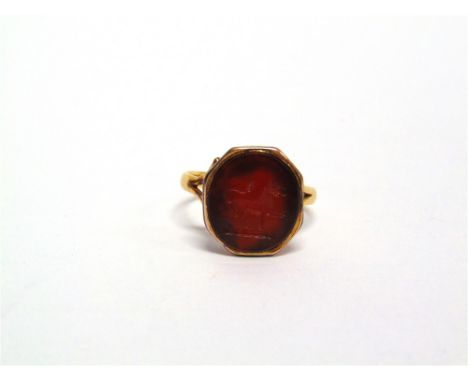 A CORNELIAN INTAGLIO CREST RING Victorian, 18 carat, finger size M, 4.3g gross