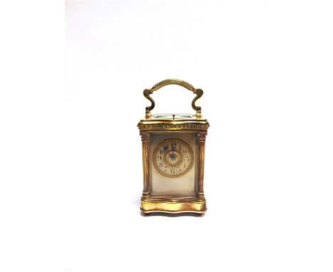 AN EDWARDIAN CARRIAGE CLOCK  with repeat mechanism, the brass case with Corinthian columns, 10cm wide 9cm deep 16.5cm high