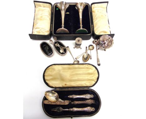 A PAIR OF SILVER SALTS with glass liners; a silver mustard pot; a silver pepperette; eight silver cruet spoons; a cased Victo