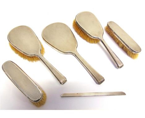 A FIVE PIECE SILVER DRESSING TABLE SET  by R Comyns, London 1947, comprising a hand mirror, two hair brushes, and two clothes