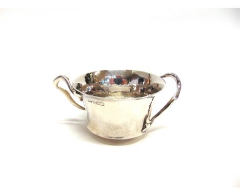A SILVER ART NOUVEAU BOWL  by Millar Wilkinson, London 1904, the hammered flared bowl with tendril handles with leaf terminal