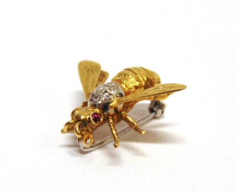 A DIAMOND AND RUBY BEE BROOCH  stamped '750', the thorax set with seven single cut diamonds, rub set eyes, 2.3cm long, 2.9cm 