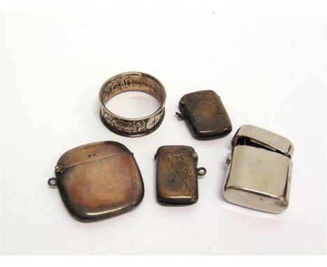 A SILVA VESTA CASE Birmingham 1913, of plain cushion shape; with two other silver vesta cases; and a silver napkin ring; 57g 