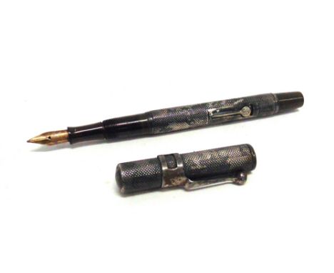 A VINTAGE WATERMAN'S SILVER FOUNTAIN PEN  with an 'Ideal' nib and lever.