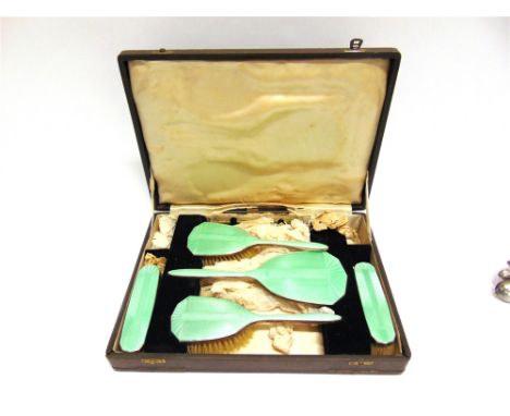 A SIX PIECE SILVER AND ENAMEL DRESSING TABLE SET  Birmingham 1927, comprising a hand mirror, two hair brushes, two clothes br