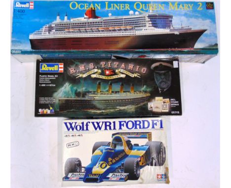 THREE UNMADE PLASTIC KITS  comprising a 1/12 scale Tamiya Wolf WR1 Ford F1, boxed (box damp damaged); 1/400 scale Revell R.M.