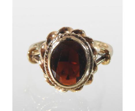 A 9 carat gold garnet ring, boxed