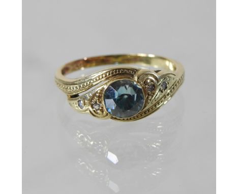 A 14 carat gold and blue zircon and diamond ring, of asymmetrical design, boxed