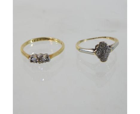 An 18 carat gold platinum set three stone diamond ring, together with another