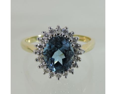 An 18 carat gold blue topaz and diamond cluster ring, boxed