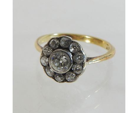 A 18 carat gold and diamond daisy ring, with valuation