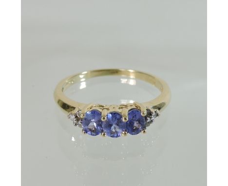 A 14 carat gold tanzanite ring, boxed, with certificate