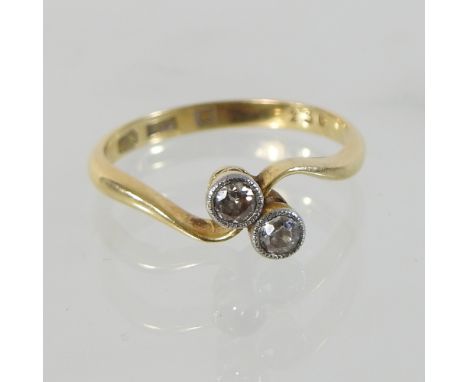 An 18 carat gold two stone diamond ring, of crossover design, boxed