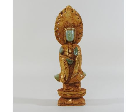 A Chinese jade and russet figure of Guanyin, 34cm high