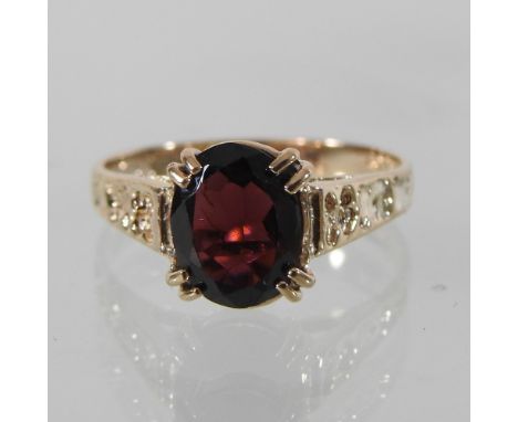 A 9 carat gold garnet ring, boxed