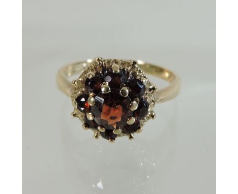 A 9 carat gold garnet cluster ring, boxed