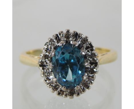 A 14 carat gold blue topaz and diamond cluster ring, boxed 