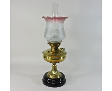 A Victorian brass oil lamp, with a glass shade, 59cm high