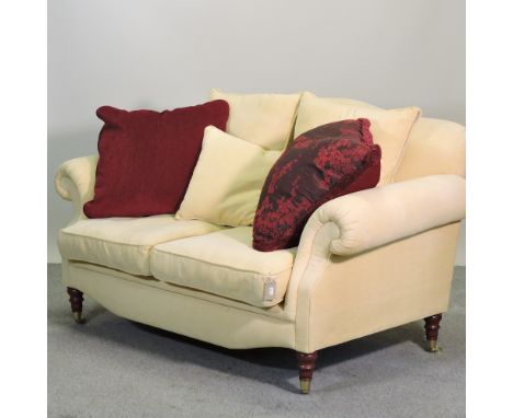 A yellow upholstered two seater sofa, on turned legs, 160cm, with cushions