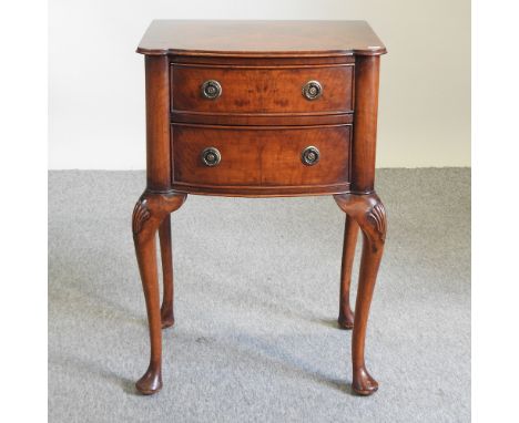 An early 20th century bow front side cabinet, containing two drawers, on cabriole legs, 50cm