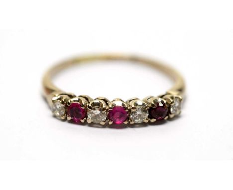 A ruby and diamond ring, the three round rubies parted by round brilliant cut diamonds, in yellow metal, marks worn.