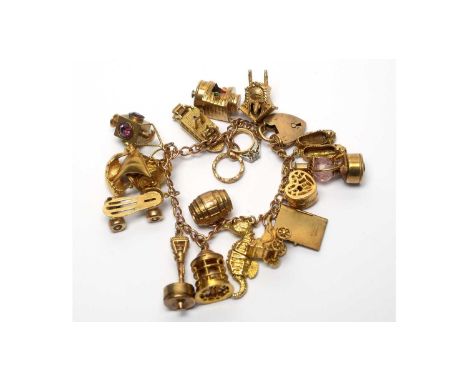 A 9ct yellow gold bracelet, mounted by mostly 9ct yellow gold charms, including slippers, car, barrel, roller skate, boat, pa