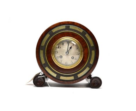 An unusual late 19th/early 20th Century mantel clock, of cylindrical form, the circular silvered Arabic dial within brass cas