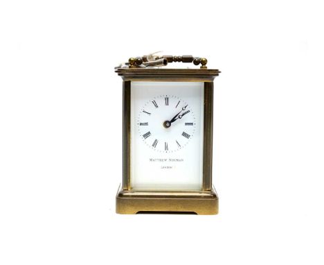 A 20th Century Matthew Norman brass cased carriage clock, the white dial with Roman numerals in black, platform lever escapem