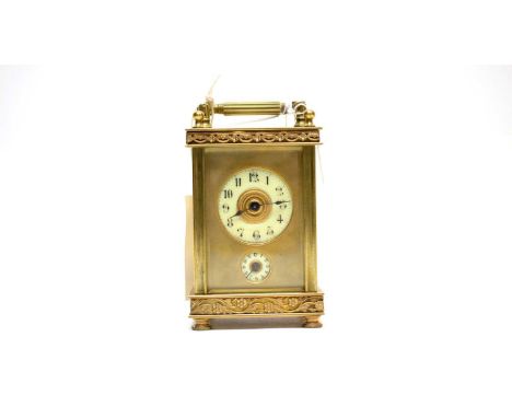 A 19th Century brass carriage clock, with Arabic enamel dial, subsidiary enamel alarm dial, pierced and embossed flower motif