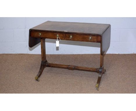 A Regency style mahogany sofa table, with rectangular double-flap top above two frieze drawers, rectangular section supports 