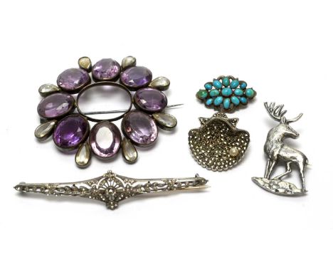 An amethyst and rock crystal brooch in silver mount; a paste set belle epoque silver brooch; a marcasite shell pattern silver