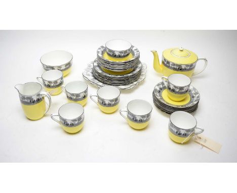 A Foley tea service, decorated with a band of yellow below a monochrome band illustrating silhouettes of figures in the fores