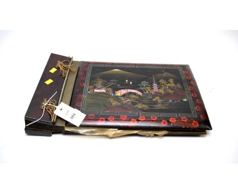 A Japanese lacquered and inlaid musical photograph or postcard album, the cover with abalone and mother of pearl inlaid mount