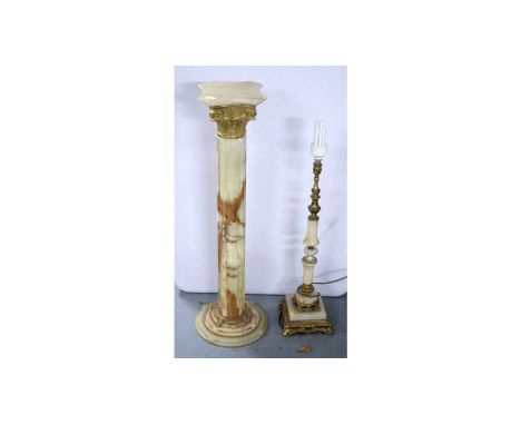 A French onyx and gilt metal pillar pedestal stand, 96cms high; together with a similar table lamp. (2) 