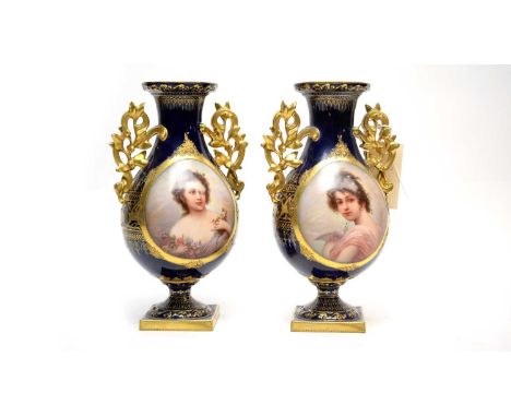 A pair of Royal Vienna style twin handled vases, each illustrating the portrait of a lady, lacking covers, 24cms high. 