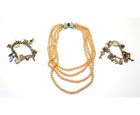 Two silver charm bracelets, various charms, some enamel; and a faux pearl necklace. 