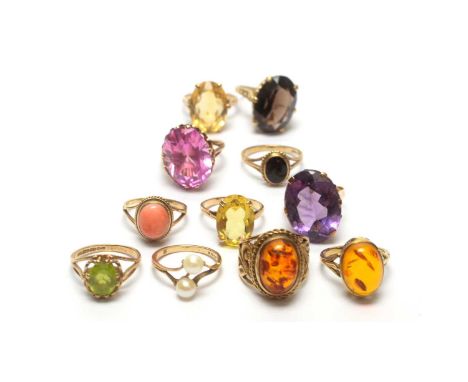 Eleven gemstone set dress rings, all set in 9ct yellow gold, stones including: amber, synthetic pink sapphire, onyx, amethyst