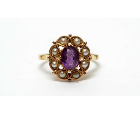 An amethyst and pearl ring, the oval facet-cut amethyst within star-pattern mount surrounded by half-pearls, in 9ct mount and