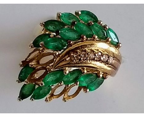 A mid-20th century emerald and diamond dress ring on a yellow gold setting, stamped 14K 585, size K, some stones missing, 6.2