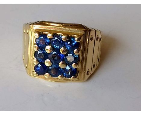 A sapphire set ring of three rows, mixed cut medium blue sapphires measuring 3.1mm diameter, sapphire weight 1.25 carat, mark