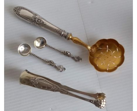 An early 20th century French silver soup ladle, 34.5 cm, sugar tongs, silver-handled sifter with gilt bowl, and a pair of Vic