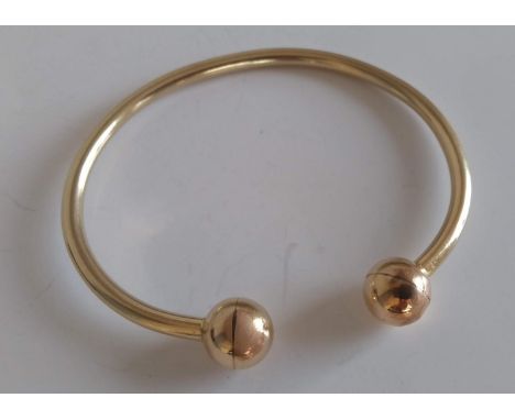 A yellow gold bangle, 7 cm, not hallmarked, tests for 18ct gold, 31g 