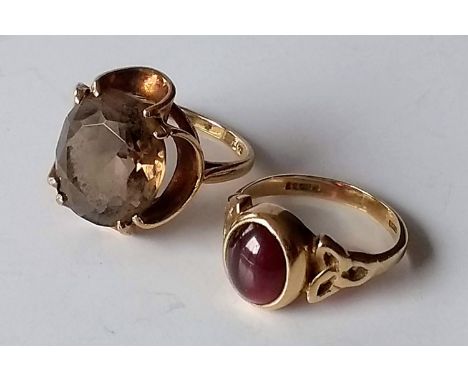 A mid-20th century gold and citrine (13mm diam.) dress ring in a claw setting, size K1/2, hallmarked 9ct, 4.28g and an oval-c