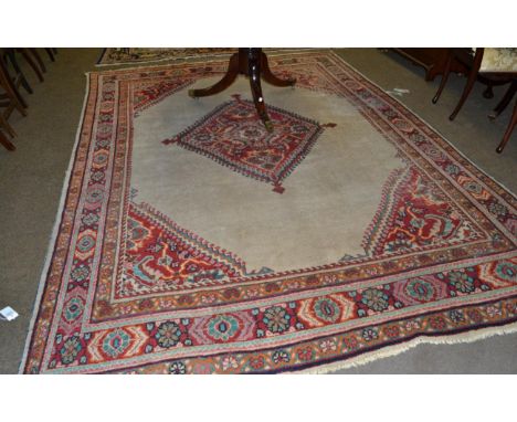 Mahal carpet, West Iran, the cream field centred by a stepped medallion framed by spandrels and multiple borders, 318cm by 23