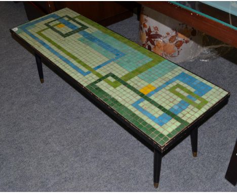 A 1960s G-plan tile-top coffee table, of rectangular form, 123cm by 41cm by 41cmSeveral of the mosaic tiles with small chips,