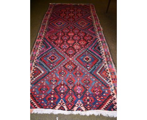 Van Hakari Kilim, East Anatolia, the field of multiple serrated medallions enclosed by borders of comb motifs, 335cm by 155cm