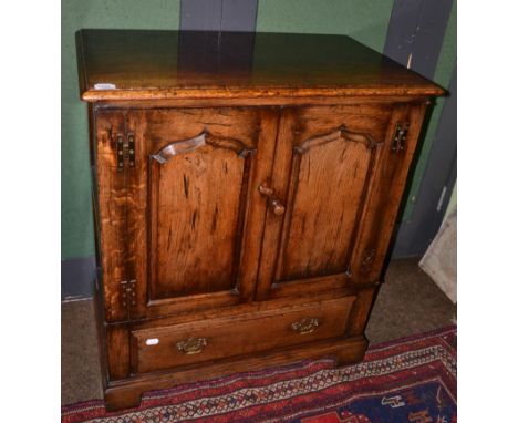 A Titchmarsh & Goodwin Oak Television Cabinet, model RL776/NC, two fielded cupboard doors with H brass hinges, a long drawer 