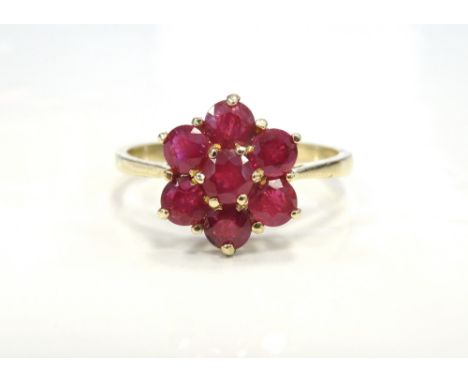 RUBY CLUSTER RINGthe seven rubies in flower head design setting, on nine carat gold shank, ring size O